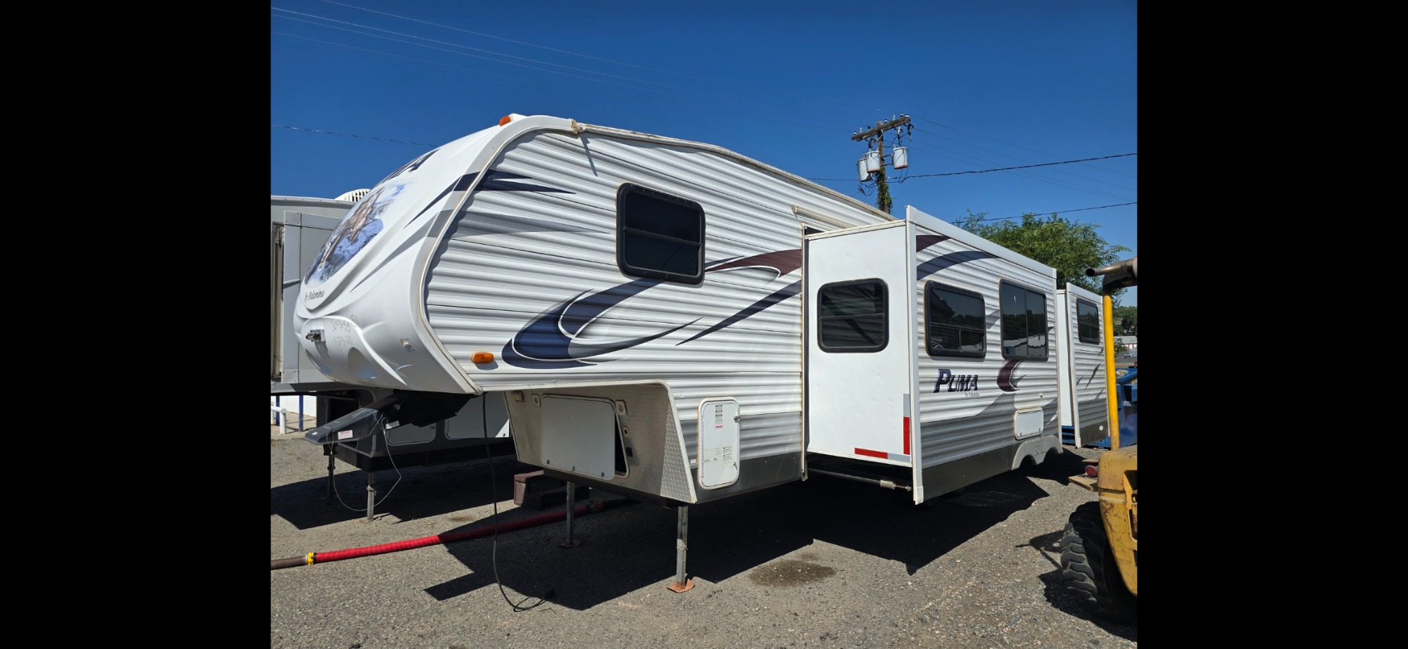 photo of 2012 Palomino Puma 5th wheel 2 slides triple bunks 