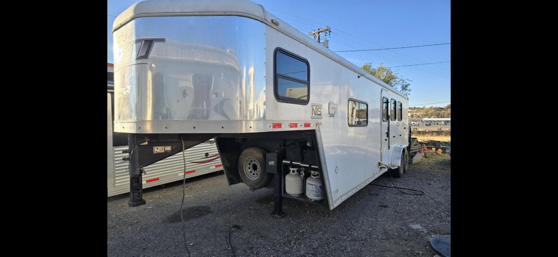 2014 White HHT 3 Horse LQ , located at 923 US HWY 87 E., Billings, MT, 59101, (406) 245-0456, 45.795788, -108.451881 - 3 horse slant 30' overall length with Living Quarters. 9' shortwall, 6' 7" door opening, horse area short side 10' long side 14'. A/C, forced air heat, awning, bigfoot hydraulic jack. Collapsible and removable rear tack. Aluminum on steel. John 4062080659. - Photo#1